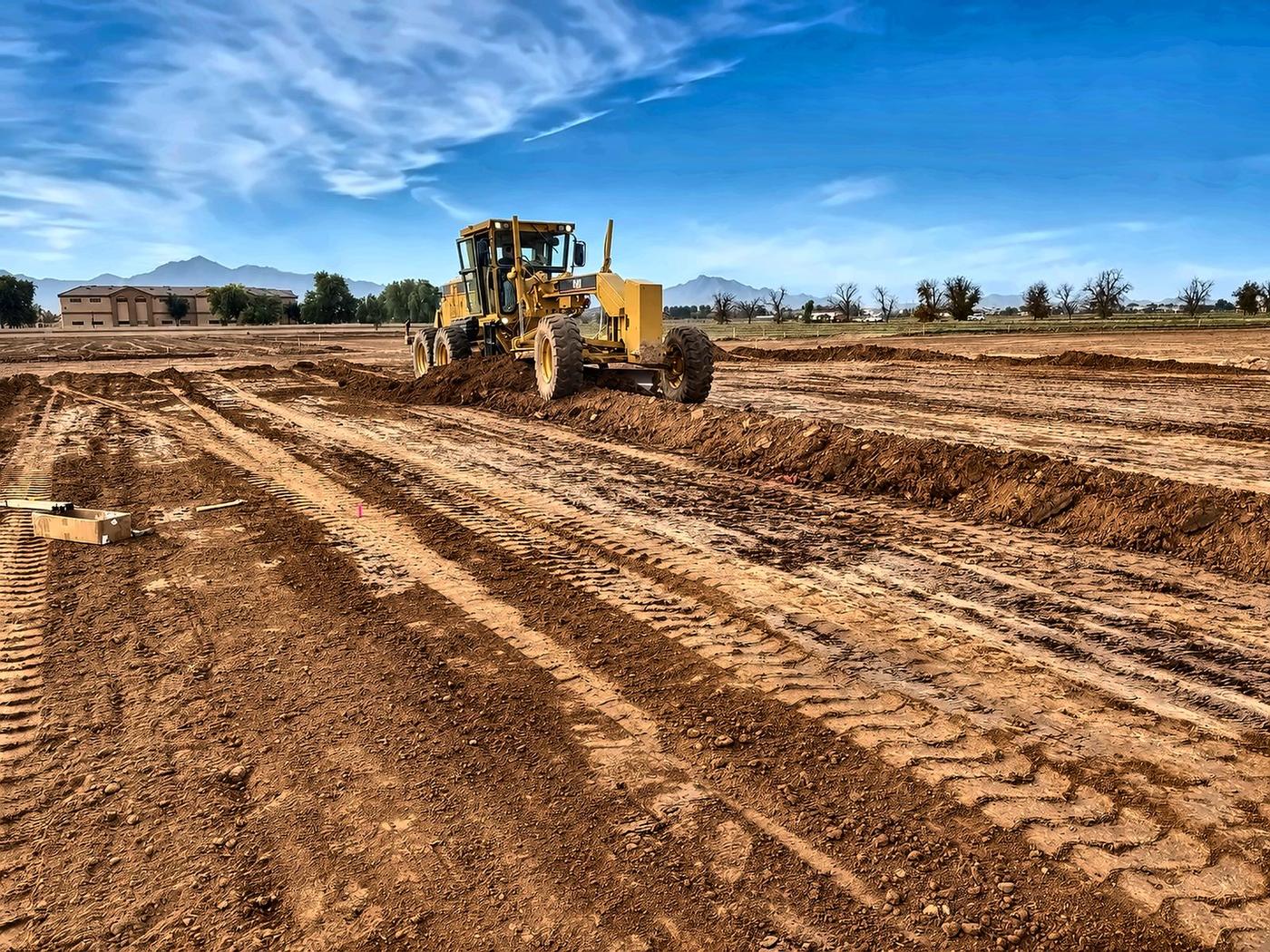 Finish grading — building pad